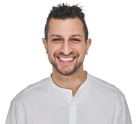 Jeremy treated with Invisalign, a professional in-office whitening and veneers on his two front teeth